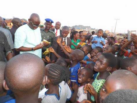 Fayose Buys And Shares Bananas To Kids In Ekiti (photo)
